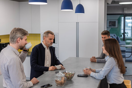 Business colleagues meeting for a coffee break, communicating and discussing work