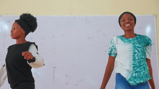 Black mother and child dancing joyfully together. Uplifting bonding session in classroom, exuberant leaps, shared smiles, playful reach and embrace, spontaneous choreography, affectionate connection,