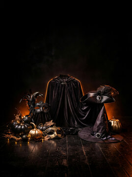 Elegant black witch hat and dark festive pumpkins for halloween celebration