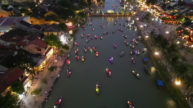 Aerial view of Hoi An old town with embankment, boats with colorful lanterns.