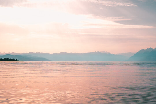 Coucher de soleil dor&eacute; et brumeux sur le lac L&eacute;man et les Alpes