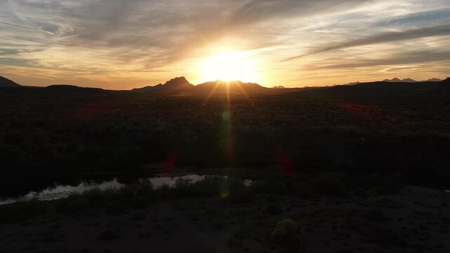 Beautiful desert scene with the sunstar overlooking the Sonoran Desert with Four Peaks in the distance.