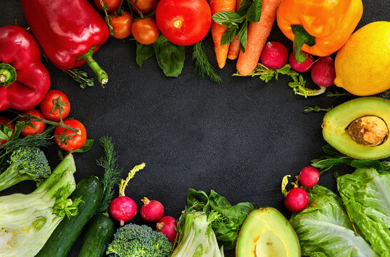 Healthy food background. Concept of Healthy Food, Fresh Vegetables and Fruits. On a black background. Top view. Copy space.