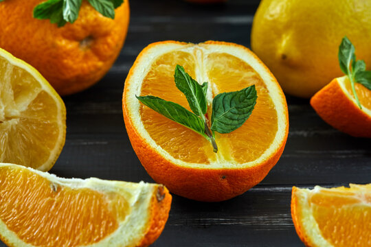Healthy food background. Healthy eating concept, fresh citrus fruits. On a black wooden background. Side view. Selective focus