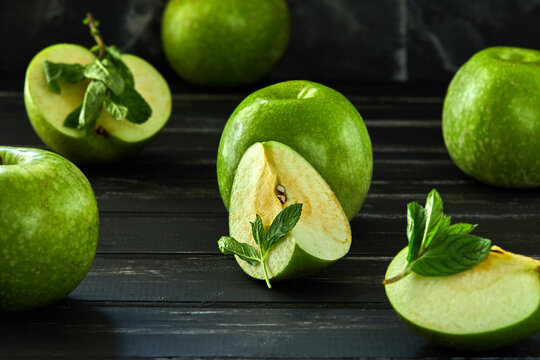 Healthy food background. The concept of healthy eating, fresh apples. On a black wooden background. Side view. Selective focus