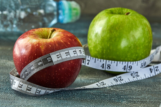 Attributes of a healthy lifestyle. Fruits and meter on a blue with divorces background. Calorie counting. Diet plan. Side view. Close-up. Sport and healthy mode.