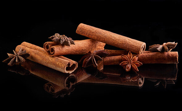 Cinnamon sticks and star anise isolated on black background