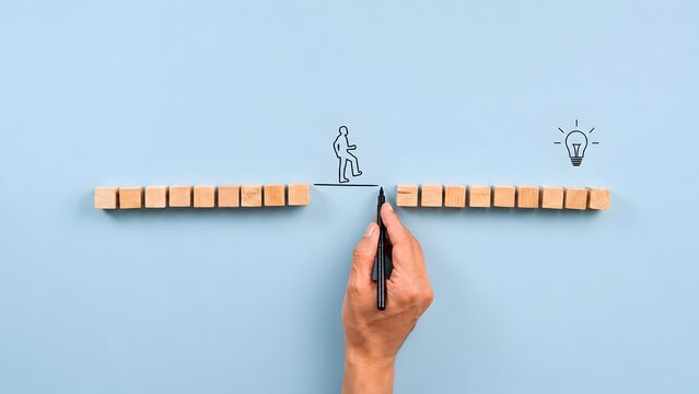 Bridging the gap concept showing hand drawing a line for a person walking towards a creative idea overcoming business obstacles