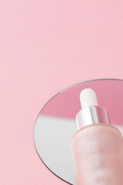 Close up of pink dropper on the mirror, luxury skincare product visuals for advertising