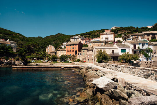 A small village along the coast surrounded by mountains and sea in Corsica