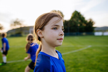 Fototapeta premium Girl football player standing on sports field before training.