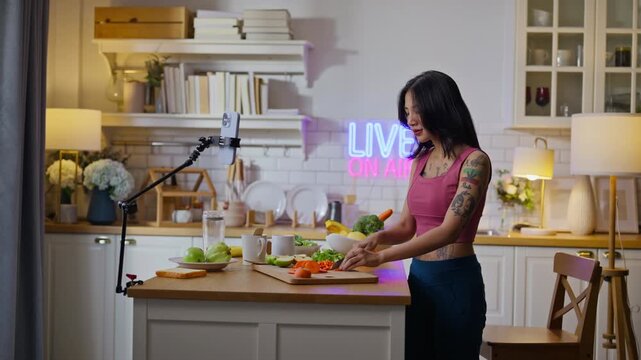 sport asian girl gen z  talk selfie video mobile phone camera to anti aging expert modern health care.vlogger or asian woman coach live in kitchen room.Online diet food weight loss HDL meal plan.