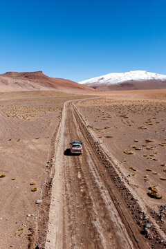 Aerial view of a four-wheel-drive on a lone desert track, Sud L&iacute;pez, Potos&iacute;, Bolivia