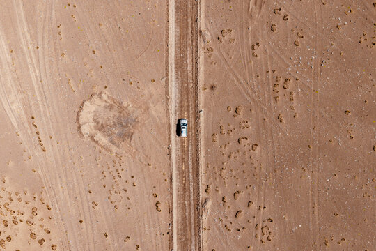 Aerial top view of a car on a desert track, Sud L&iacute;pez, Potos&iacute;, Bolivia