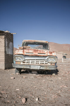 Rusty vintage truck beside a stone wall in an altiplano village, Sud L&iacute;pez, Potos&iacute;, Bolivia