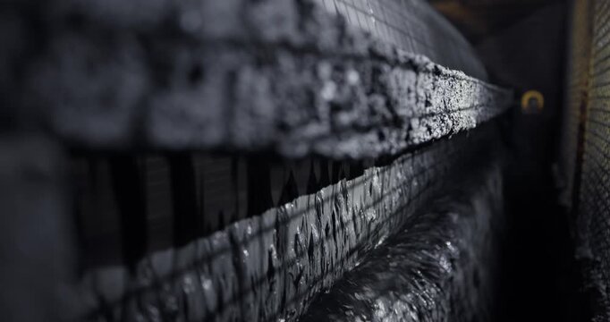 Magnetite extraction from pulp is based on wet magnetic separation with permanent magnets or electromagnets on iron production. Closeup process on Industry ore mining factory.