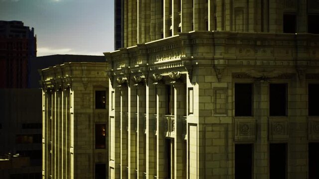Drone captures highcontrast perspective of building surface. Closeup drone image showcases contrasting light and intricate details of city building facade