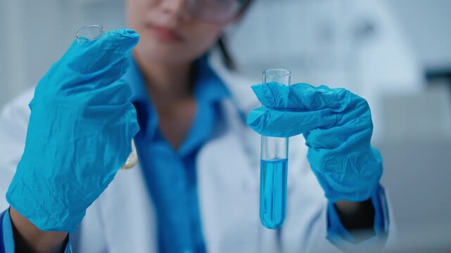 Asian Researcher using a microscope in the clinical lab.Female Researcher working in the clinical laboratory,Medical or scientific researcher or Asian woman doctor looking at professional microscope.
