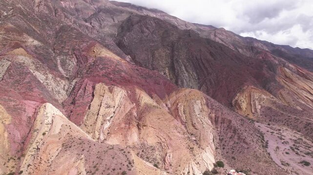 4K drone aerial view of Paleta del Pintor in Maimar&aacute;, Jujuy, Argentina. Iconic colorful mountain landscape in the Quebrada de Humahuaca, with vibrant geological layers shaped by erosion.