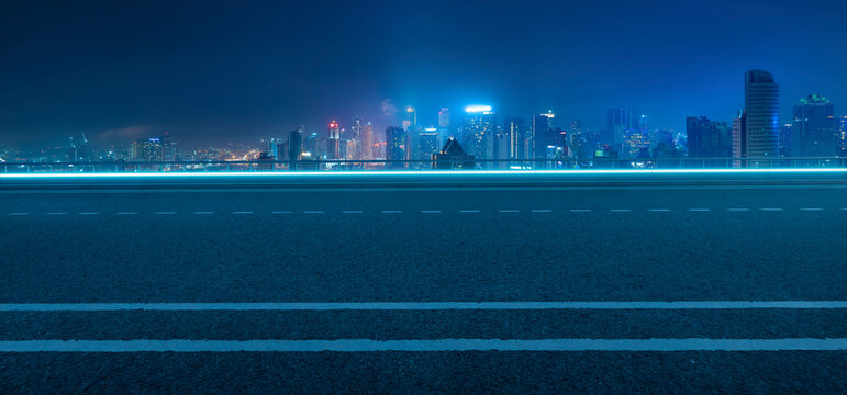3d rendering empty highway road leading to modern city skyline at night