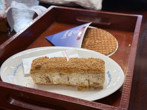 Bandung, Indonesia - July 22, 2026: A delicious display of traditional Dutch pastries featuring cream filled tompouce and sweet caramel stroopwafel inside the historic Braga Bakkerij pastry shop