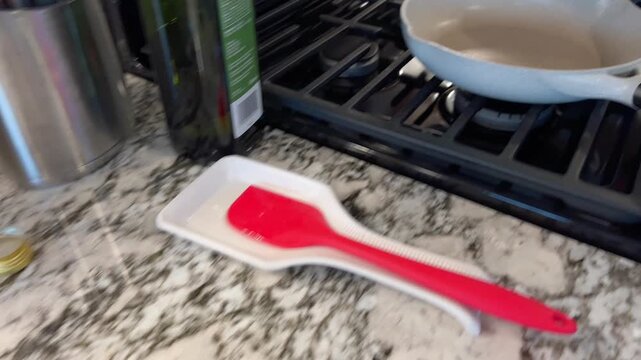 Scooping cooked hash from skillet onto plate