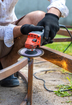 A man cutting metal with a grinder. Selective focus.