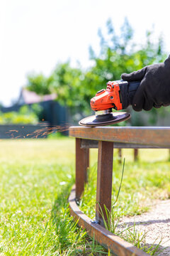 A man cutting metal with a grinder. Selective focus.