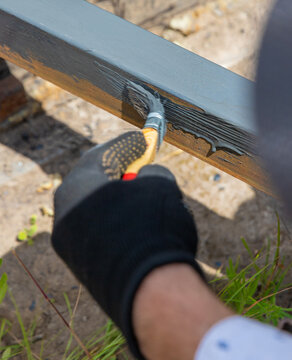 Man painting metal. Selective focus.