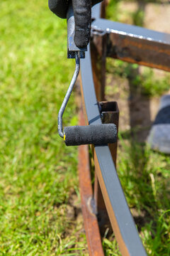 Man painting metal. Selective focus.