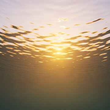Underwater view of sun rays penetrating the water surface.