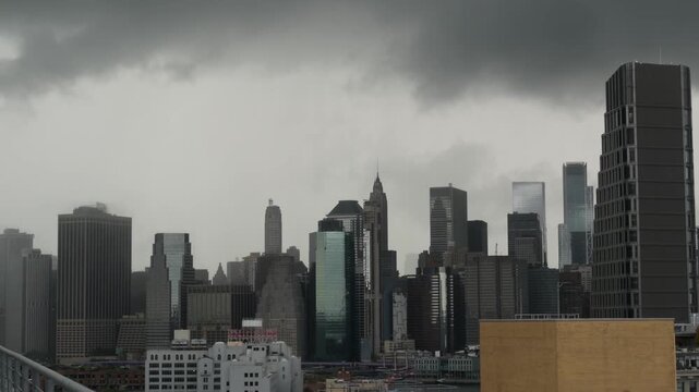 New York City Manhattan Downtown Financial District skyline, United States of America. FiDi skyscraper tower buildings. Modern business center cityscape from Brooklyn. Rain storm clouds. Thunderstorm.