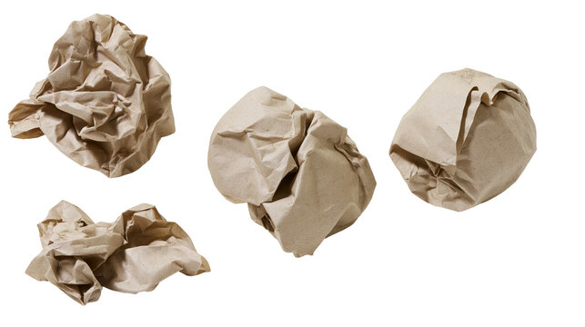Four crumpled brown paper balls scattered