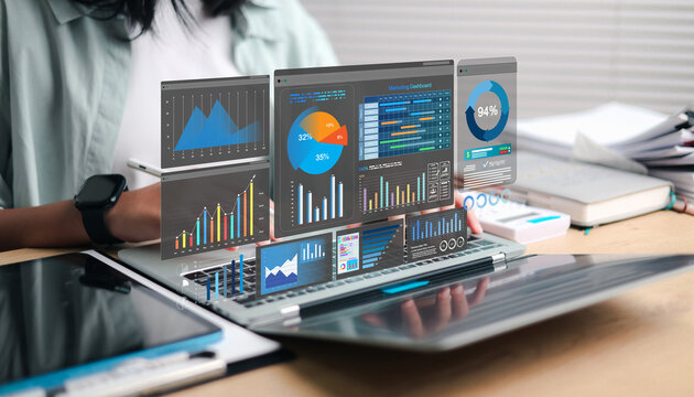 Digital marketing professional using a laptop with a virtual analytics dashboard, charts, graphs, and performance metrics, representing data analysis, business intelligence, strategy, and growth.