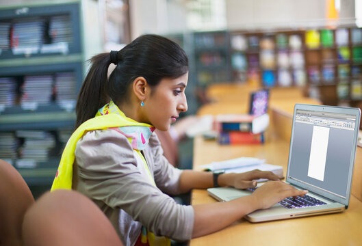 College student with laptop in library