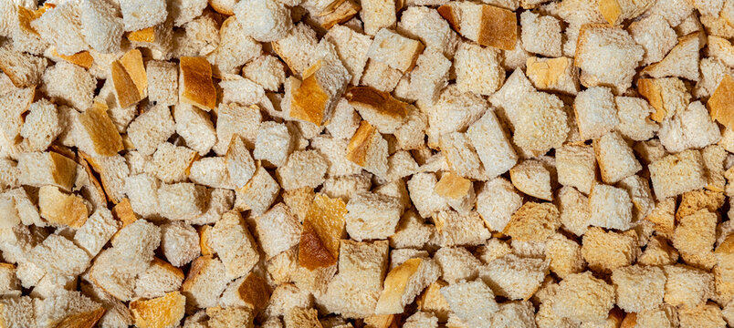 Fresh baked croutons for seasoning close up full frame as background