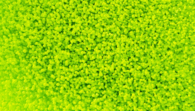 Close-up of a vibrant pile of small yellow balls forming a textured