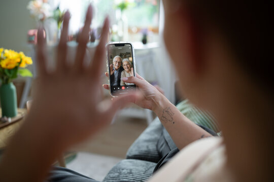 White Person video calling an older couple from home in Galicia