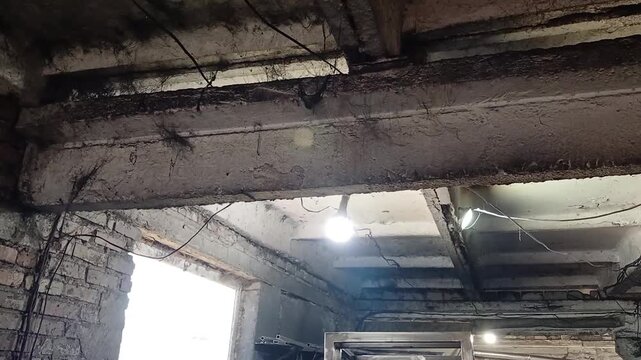 Old ceiling with white beam covered with black cobwebs