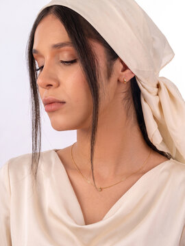 Serene Young Woman in Headscarf with Eyes Closed