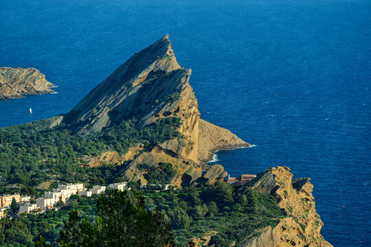 The Bec de l Aigle cliff rises above the blue sea in France