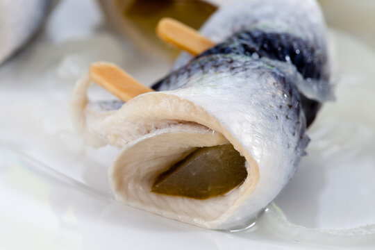 Pickled herring on plate, close up