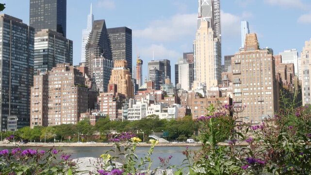 New York City Manhattan Midtown skyline from Roosevelt Island, United States. Red brick buildings architecture, riverside cityscape near East River water, Turtle Bay residential houses, real estate.