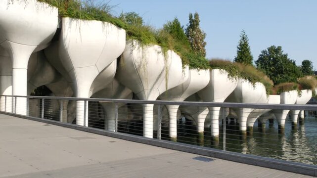 New York City Little Island pier park, oasis in Manhattan Midtown, United States. Urban architecture on pillars in Chelsea, USA. Futuristic contemporary concrete columns design, Hudson river landmark.