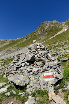 Austria, Vorarlberg, Hiking path marker on cairn