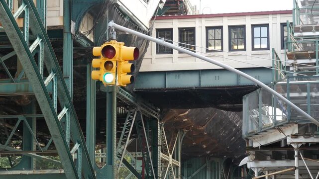 New York City 125 street elevated subway metro metallic bridge in Harlem, United States. American transport, Manhattan. Old outdoor metropolitan station, NYC USA. Historic architecture, traffic light.