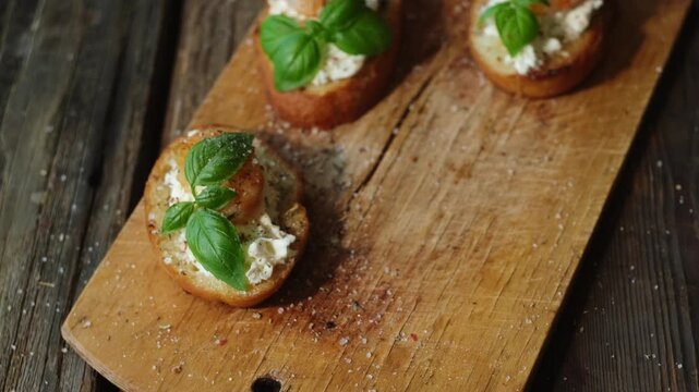Woman eating crostini with cream cheese, shrimp and fresh basil. Healthy snacks, breakfast.