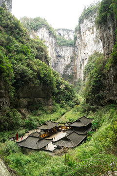 Ancient Chinese houses building surrounding  mountains and forest in the Three Natural Bridges in Wulong Karst National Geology Park (A UNESCO World Heritage Site in Chongqing China).