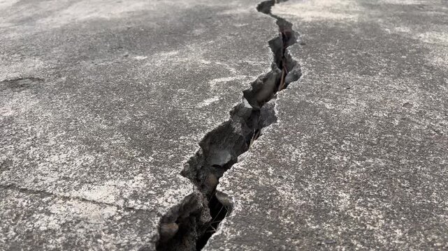 Close up of severe structural failure on a broken concrete road