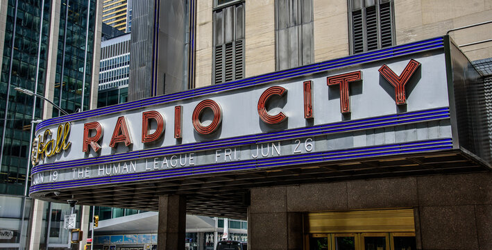 New York, New York, USA - June 14, 2026: A street-level view of the historic Radio City Music Hall sign, located in Midtown Manhattan.